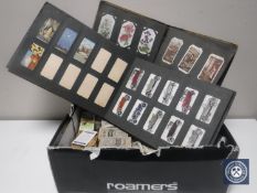 A box containing a large quantity of cigarette cards and albums