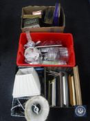 Four boxes containing tins, table lamp shades, china,