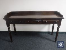 A serving table fitted with three drawers