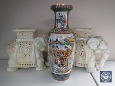 A pair of white pottery elephant plant stands together with a Japanese vase depicting Geisha