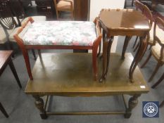 An oak extending coffee table on bulbous legs together with a mahogany piano stool and a nest of