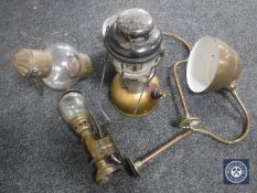 A wooden crate containing two early twentieth century brass light fittings, brass carriage lamp,