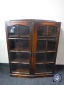 An early twentieth century oak double door bookcase