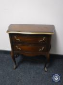 A continental two drawer chest on cabriole legs