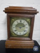 An oak cased bracket clock with brass dial