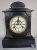 A Victorian black slate mantel clock with brass and enamelled dial