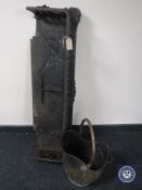 An antique cast iron fire curb together with a brass coal bucket