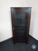 An early twentieth century oak glazed door bookcase
