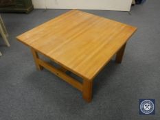 A contemporary square coffee table