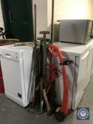 A bundle of assorted garden tools together with an electric strimmer