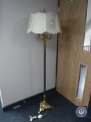 An ornate gilt standard lamp with shade