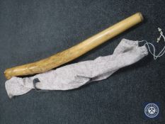 A didgeridoo in cloth carrying bag
