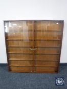 A teak wall mounted glass double door display cabinet