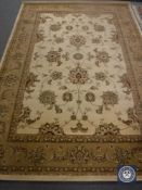 A machine made floral rug on beige ground