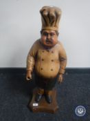 A wooden figure of a baker
