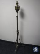 An antique brass rise and fall standard oil lamp