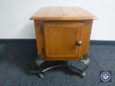 A contemporary pine cupboard on metal legs