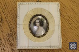 A portrait miniature depicting a lady with flowers in her hair, 10.5 cm x 9.5 cm.