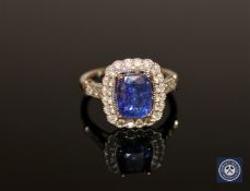 An 18ct white gold tanzanite and diamond ring, the cushion-cut tanzanite weighing 2.