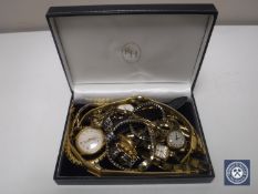 A collection of wristwatches and chains,