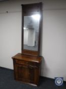 A late 19th century mahogany cupboard and a hall mirror
