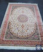 A Keshan carpet on beige ground,