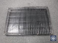 A folding metal dog cage