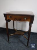 A Victorian mahogany flap sided occasional table on ceramic castors