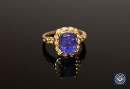 An 18ct gold tanzanite and diamond ring, the cushion-cut tanzanite weighing 4.