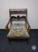 A continental mahogany scroll armchair