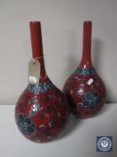 A pair of red floral pottery vases,