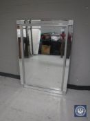 An all glass framed bevelled mirror