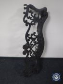 An antique cast iron fire curb