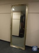 A tall traditional style mirror in a silvered framed,