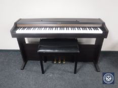 A Roland electric piano with stool
