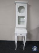 A painted wall cabinet (formerly a clock case) together with a contemporary white plant stand