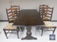 An oak refectory dining table together with a set of four ladder back chairs