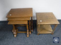 A nest of three oak tables together with an oak lamp table