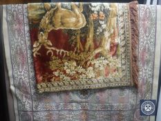 A fringed Persian design rug together with a wall hanging depicting stags