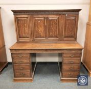 An Edwardian panelled oak secretaire bureau by Sopwith & Co.