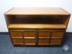 A teak entertainment stand fitted cupboard beneath