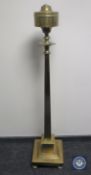 An antique brass standard lamp
