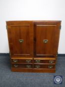 A reproduction campaign style double door audio cabinet