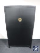 A six drawer campaign style chest in a black finish