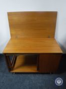 A teak turnover top coffee table fitted a table beneath