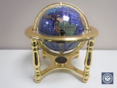 A gemstone globe on stand