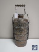 An Eastern embossed four division spice caddy with handle in copper finish