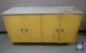 A mid 20th century four door kitchen cabinet