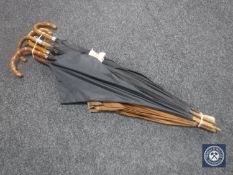 A bundle of six vintage umbrellas : one with silver pommel and three with silver mounts