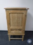 A blonde oak cabinet
